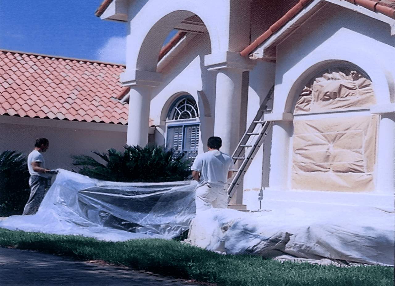 A man standing on the steps of a house