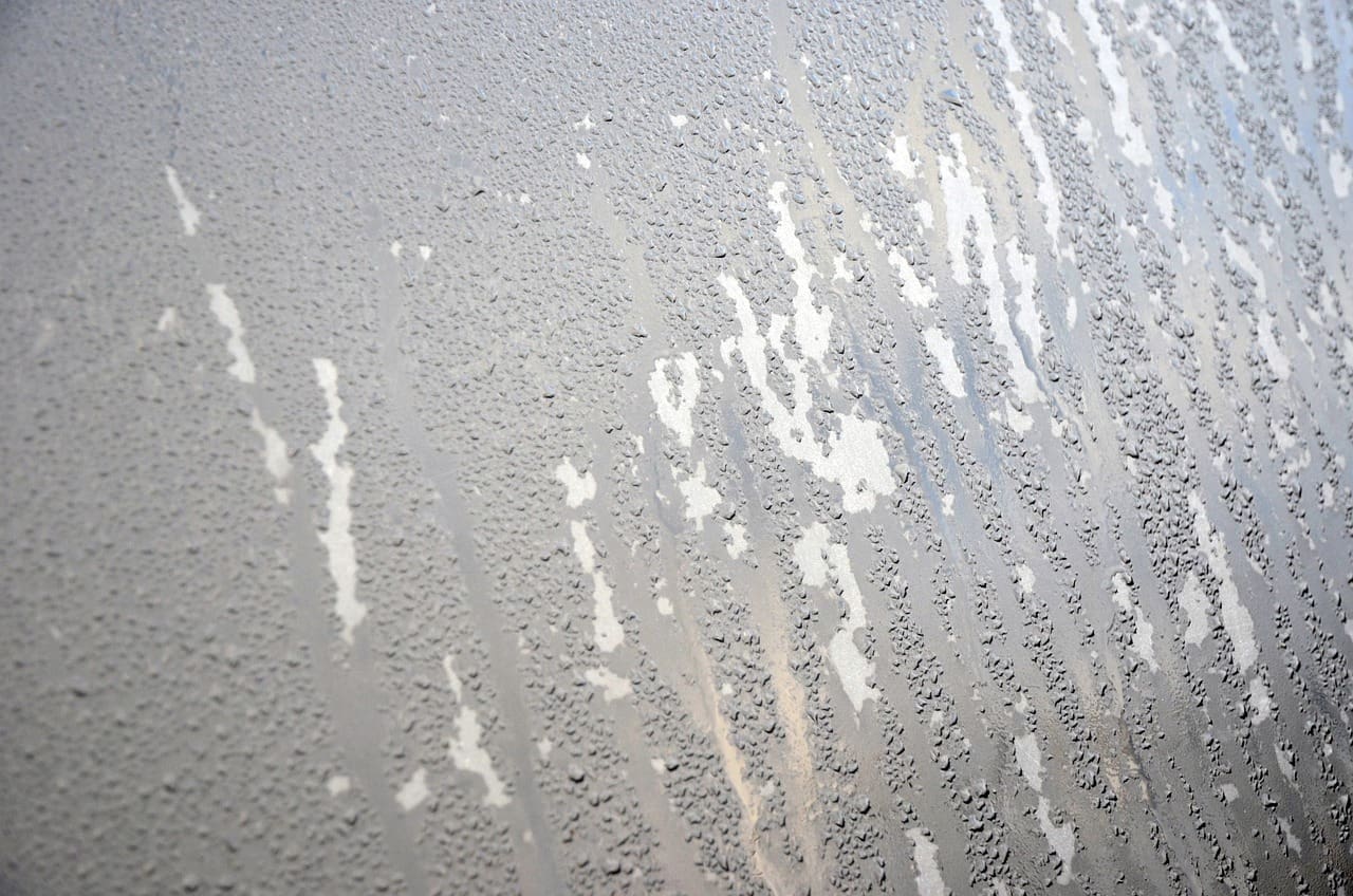 A glass window with water drops on it.